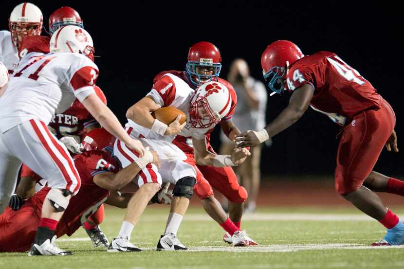 Cameron Smith (1) of Terrell Tigers is tackled by the Carter Cowboys defense at...