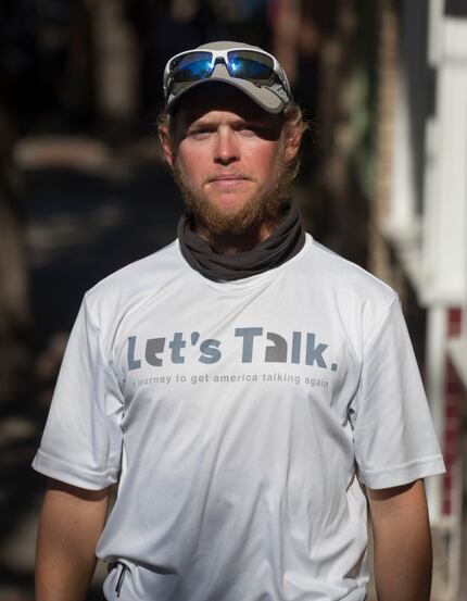 Andrews  is walking across the country to promote face-to-face communication. 