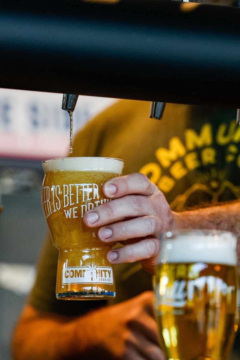 A worker pours beer into a glass at Community Beer Co. in Dallas.