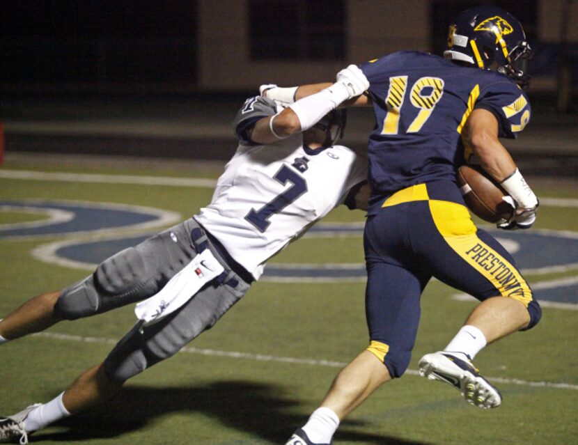 Prestonwood Christian Academy wide receiver Stephen Riegel (19) breaks through the grasp of...