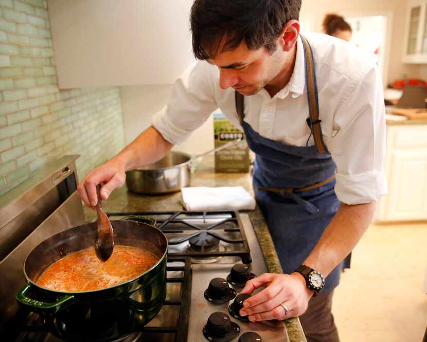 Restaurant owner and chef Julian Barsotti stirs bolognese sauce for the elaborate,...