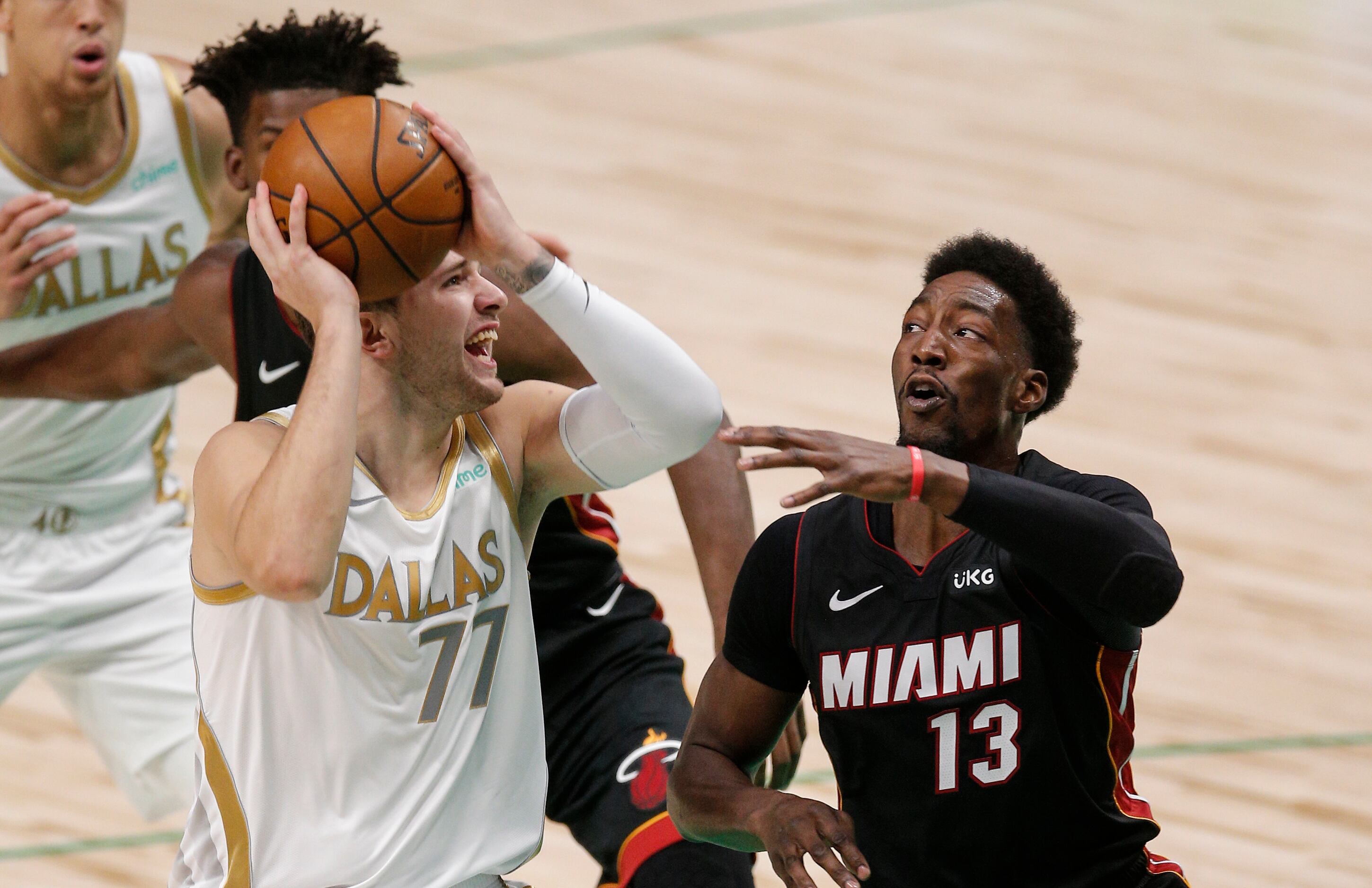 Dallas Mavericks guard Luka Doncic (77) attempts a shot as Miami Heat forward Bam Adebayo...