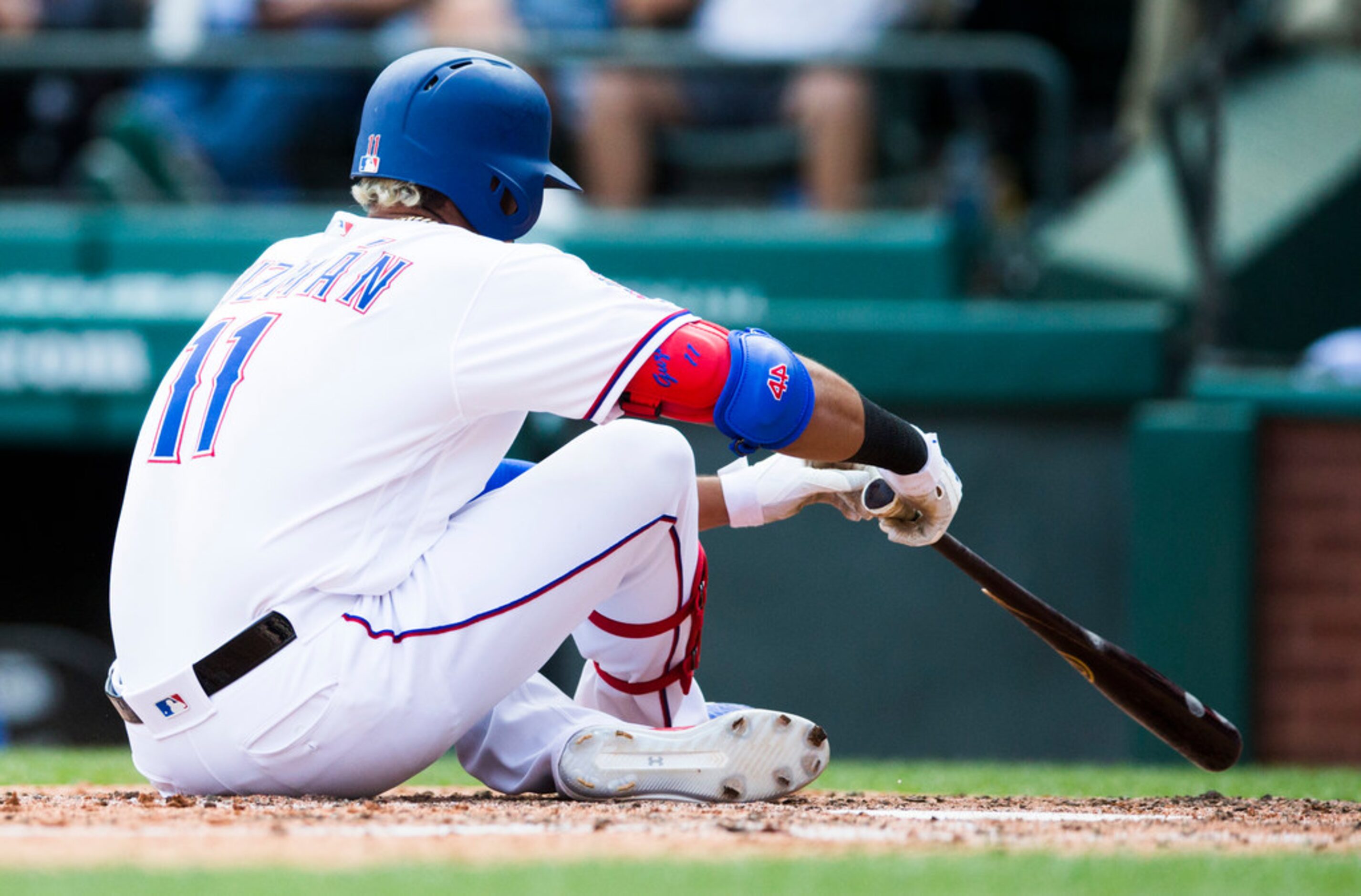 Texas Rangers first baseman Ronald Guzman (11) reacts after a ball deflected from his broken...