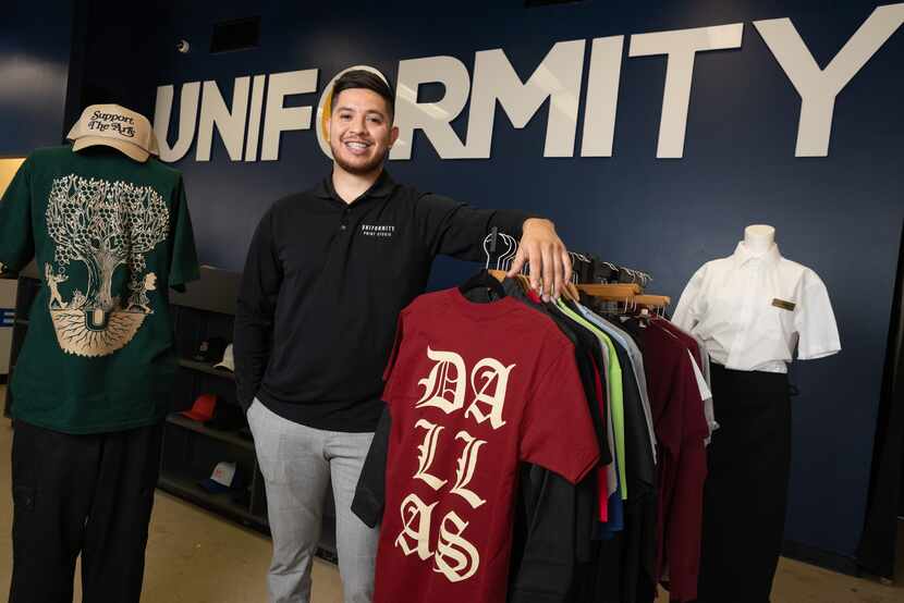 Alberto Garcia, founder and owner of Uniformity, shows off clothing his company printed and...