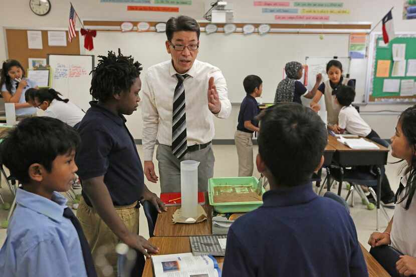 Teacher Hoc Vu works with students in a science class at Dallas ISD's McShan Elementary in...