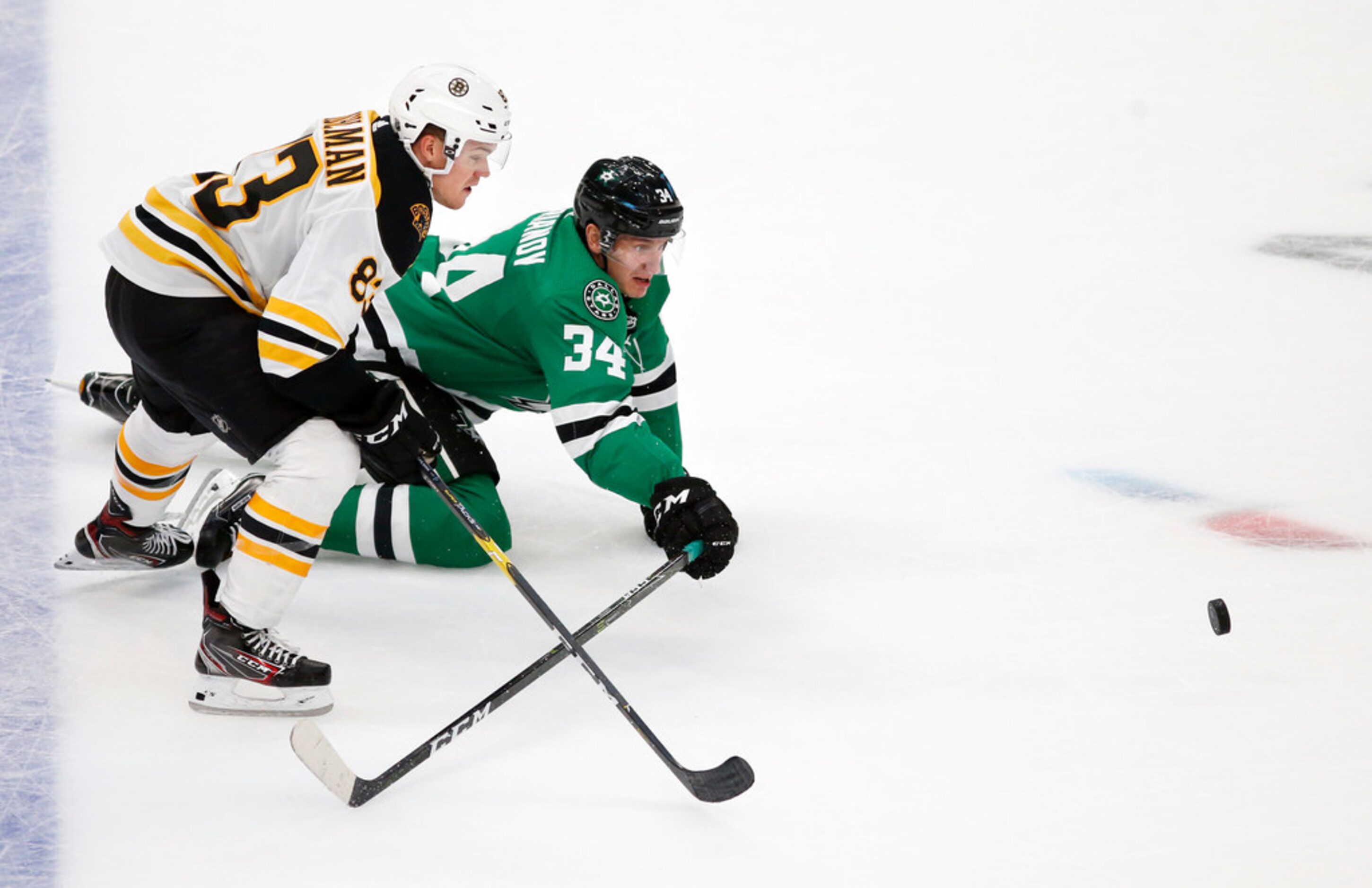 Dallas Stars right wing Denis Gurianov (34) falls as Boston Bruins center Karson Kuhlman...