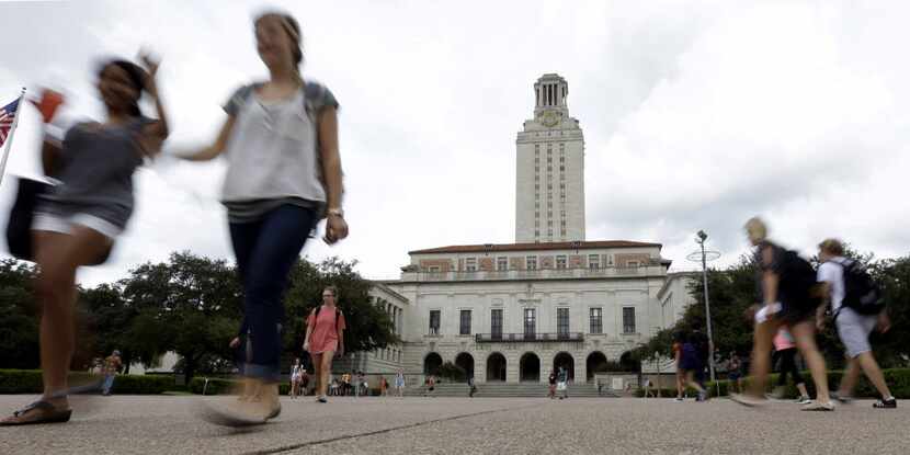 Students cross the University of Texas at Austin campus near the school's iconic tower....
