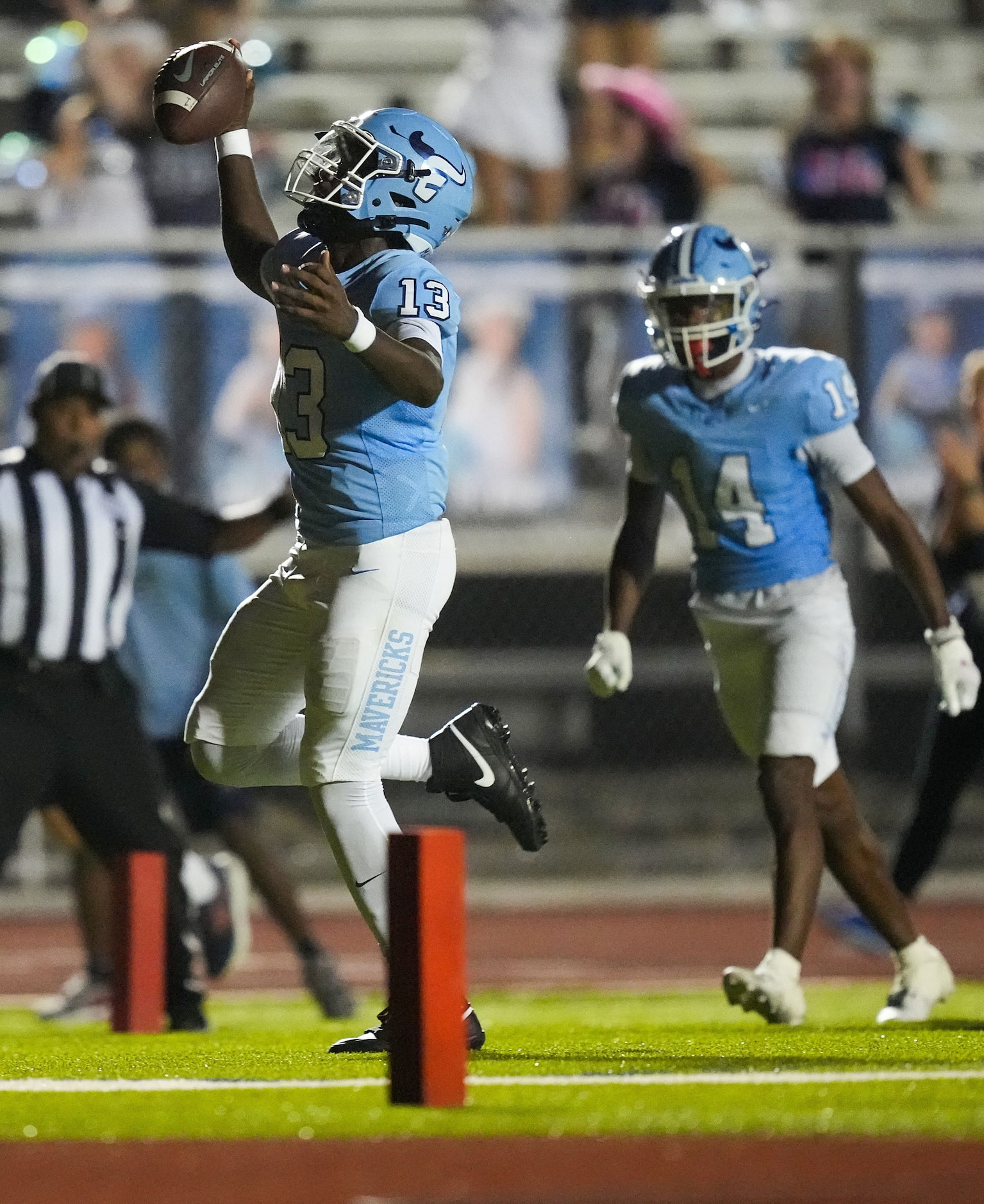 Frisco Emerson quarterback DJ Shelton (13) scores on a touchdown run during the second half...