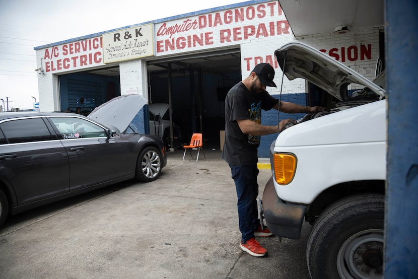 Jefferson Rincon works on a van’s spark plugs at R & K Auto Repair on Thursday, May 30,...