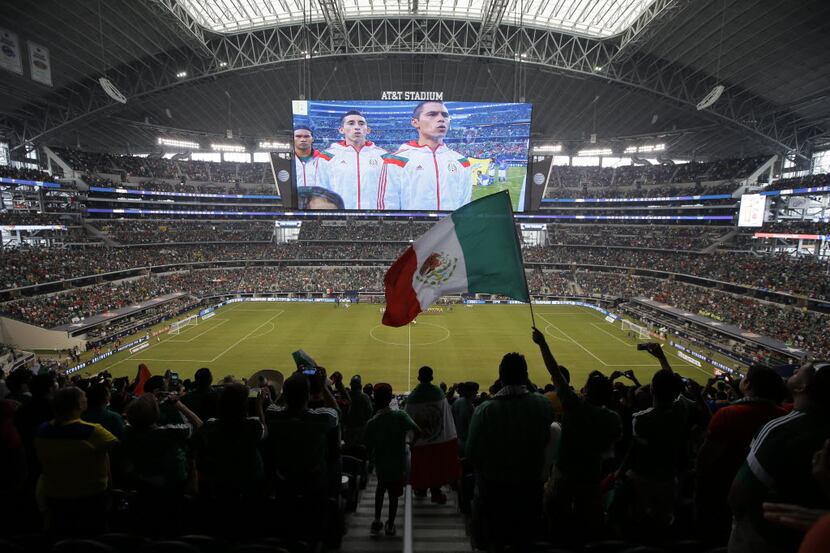 FILE — A Mexico fan waves a national flag during the playing of the Mexican national anthem...