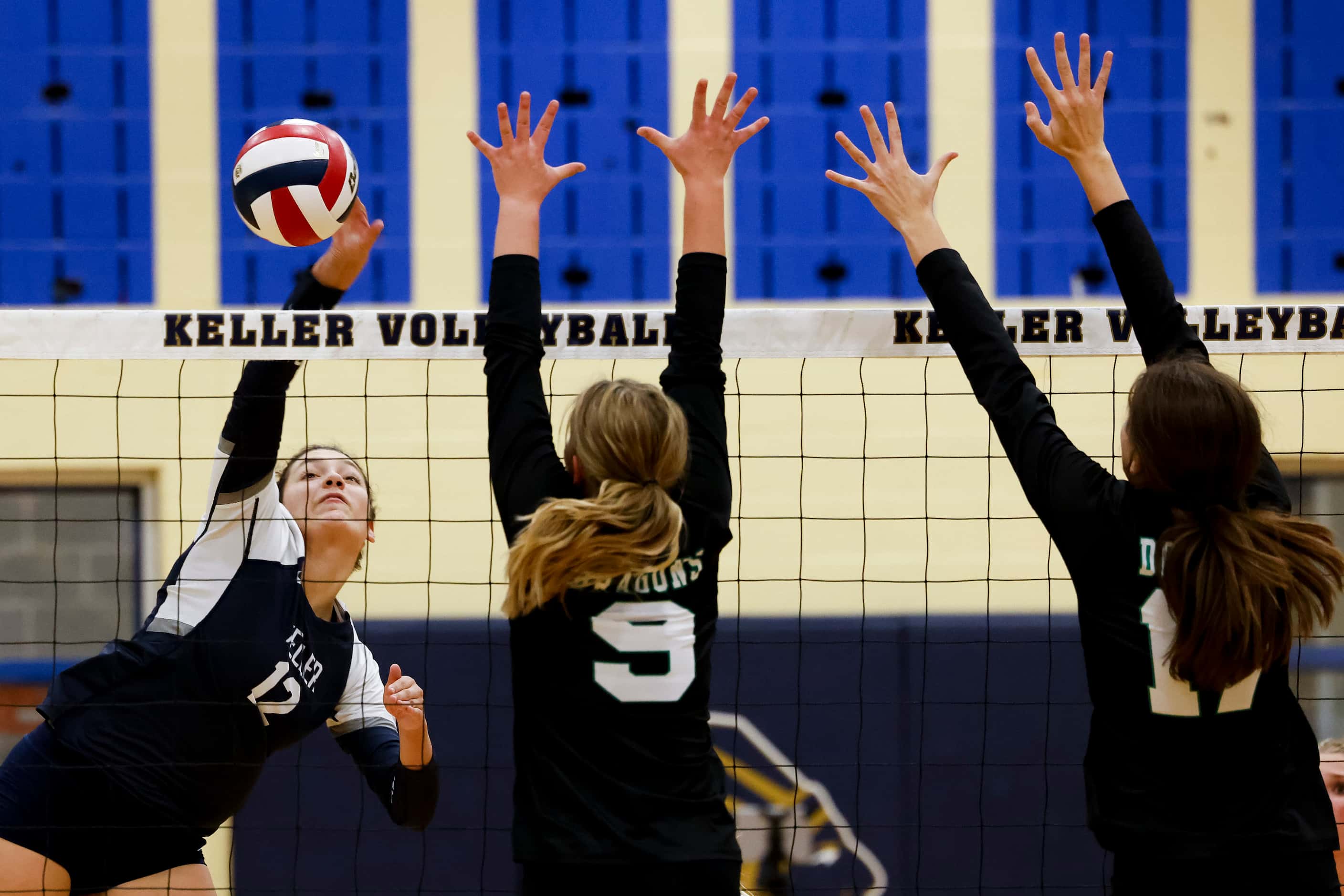 Keller’s Anna Flores (12) hits the ball against Southlake Carroll’s Taryn Barnes (9) and...