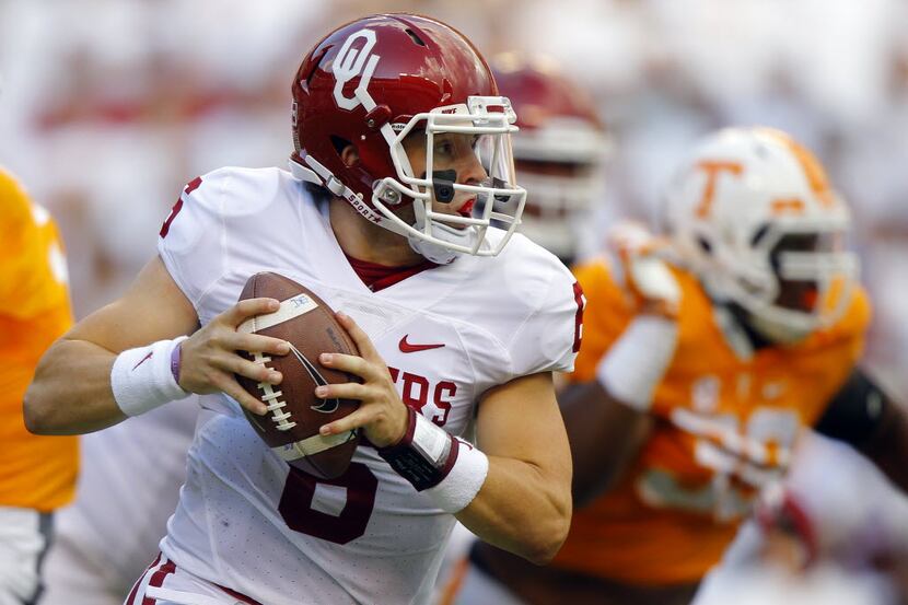 Oklahoma quarterback Baker Mayfield (6) runs for yardage during the first half of an NCAA...