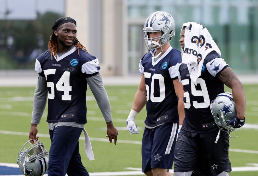 Dallas Cowboys' Jaylon Smith (54), Sean Lee (50) and Anthony Hitchens (59) walk off the...