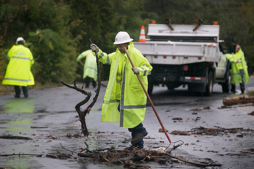 Floyd Taylor, with the City of Austin Watershed Protection department, cleaned debris that...