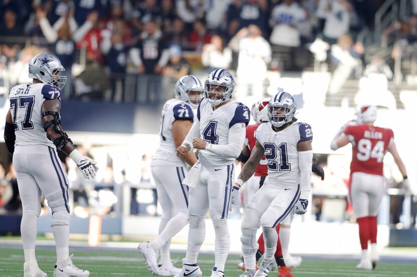 Dallas Cowboys quarterback Dak Prescott (4) celebrates after completing a pass for a...