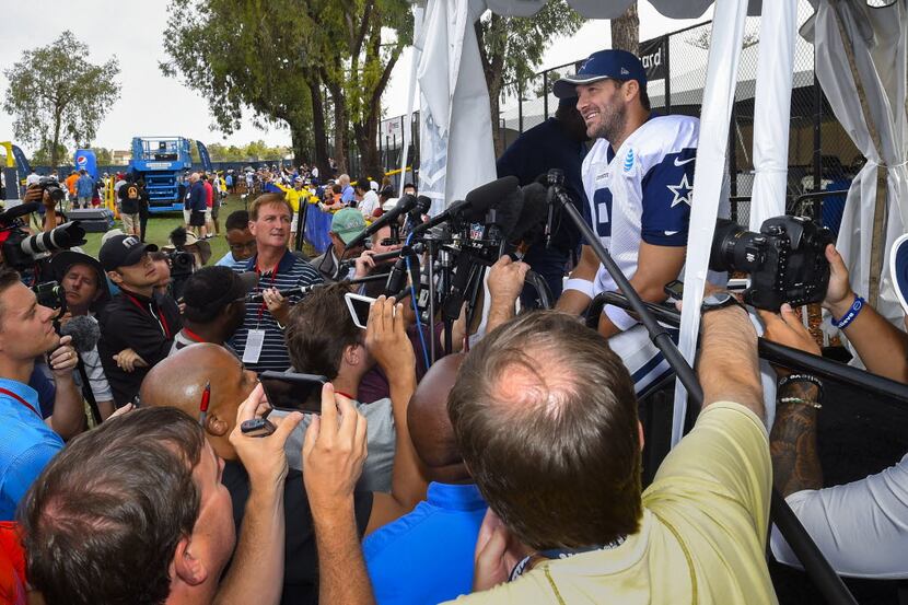 Dallas Cowboys quarterback Tony Romo takes to reporters at the end of practice during Dallas...