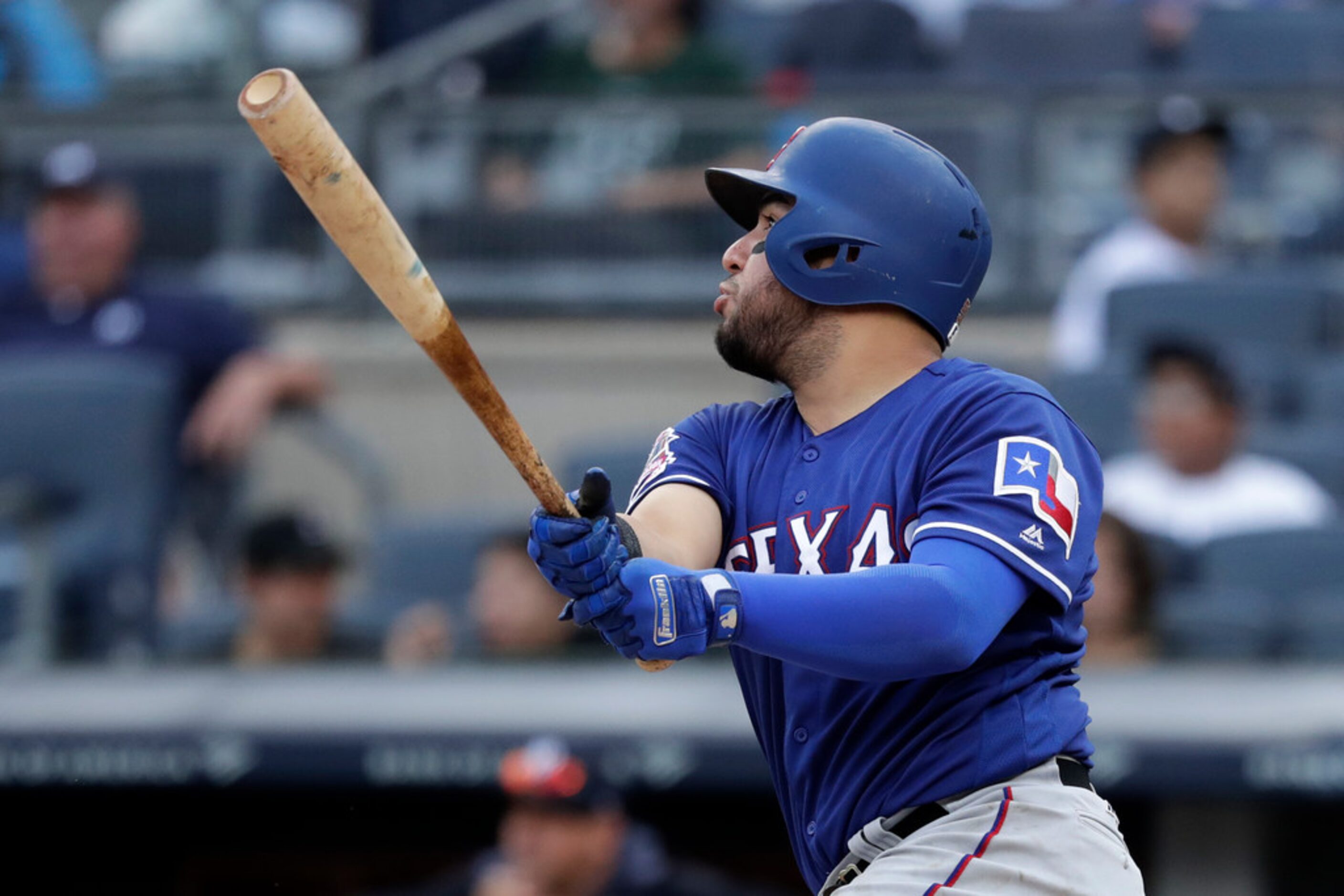 Texas Rangers' Jose Trevino hits a solo home run during the fifth inning of a baseball game...