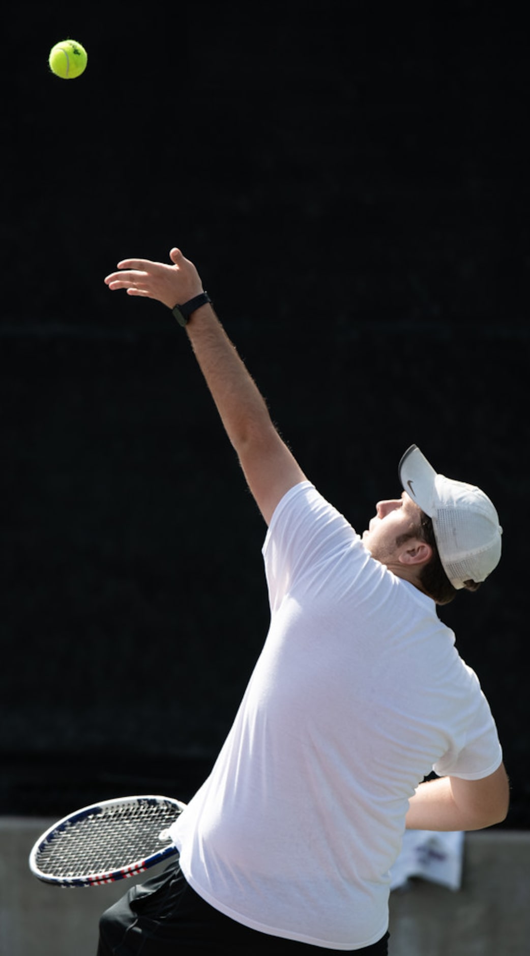 Midlothian Heritage's Joshua Windham serves the ball in a doubles match with teammate Gabe...