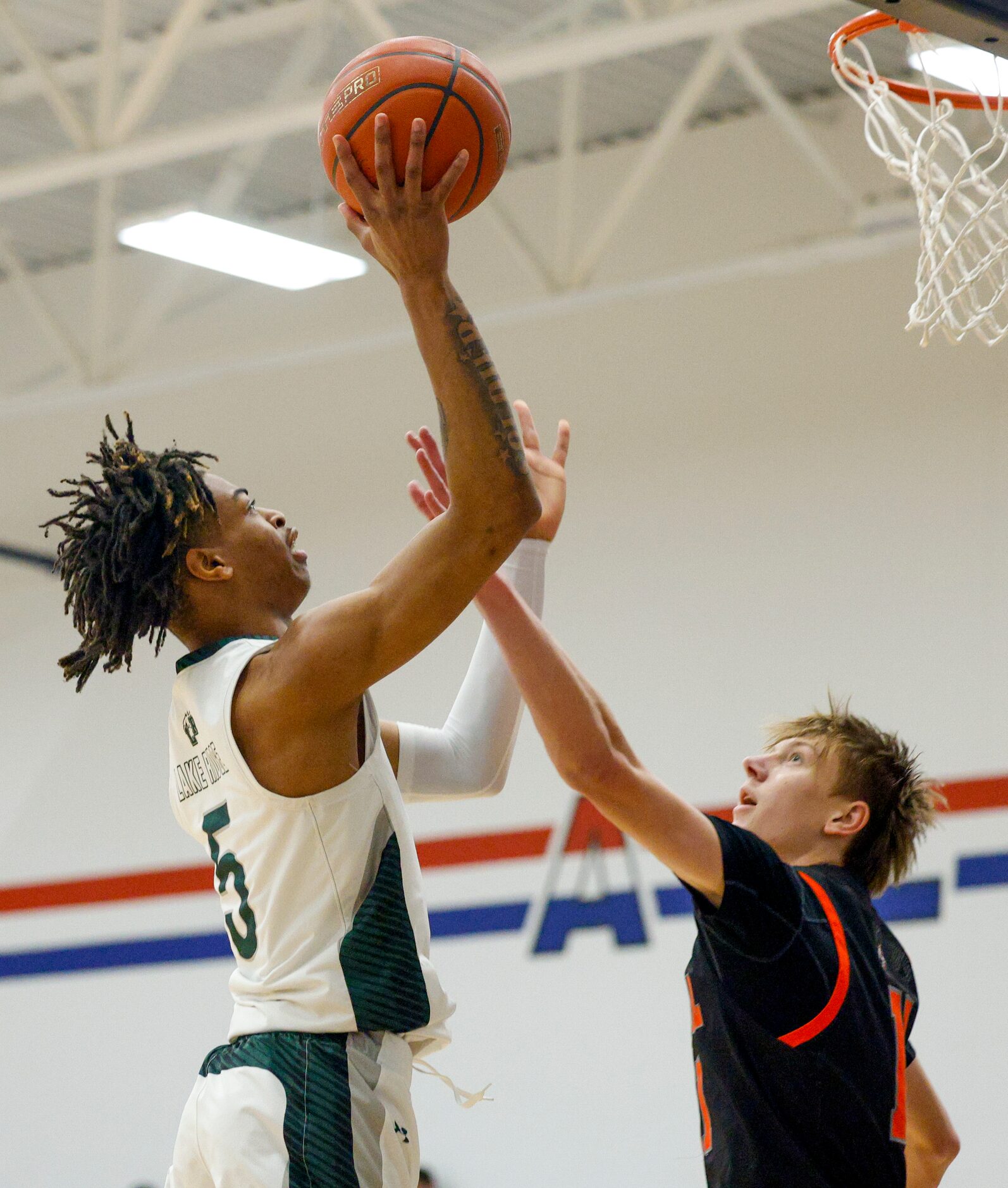 Mansfield Lake Ridge's Ahmare Rose (5) shoots over Rockwall's Corbin Brown (11) during the...