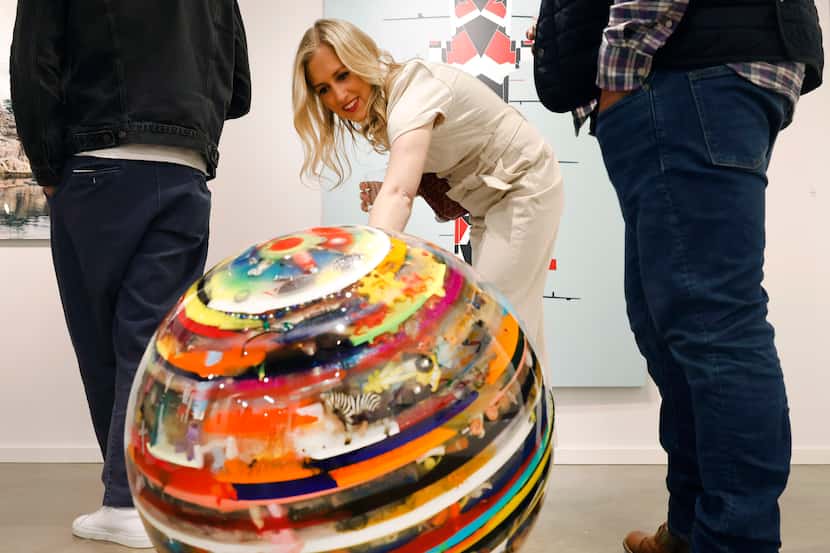 During a previous Dallas Arts Month in 2022, Alexa Kern of Dallas admires the little toys...