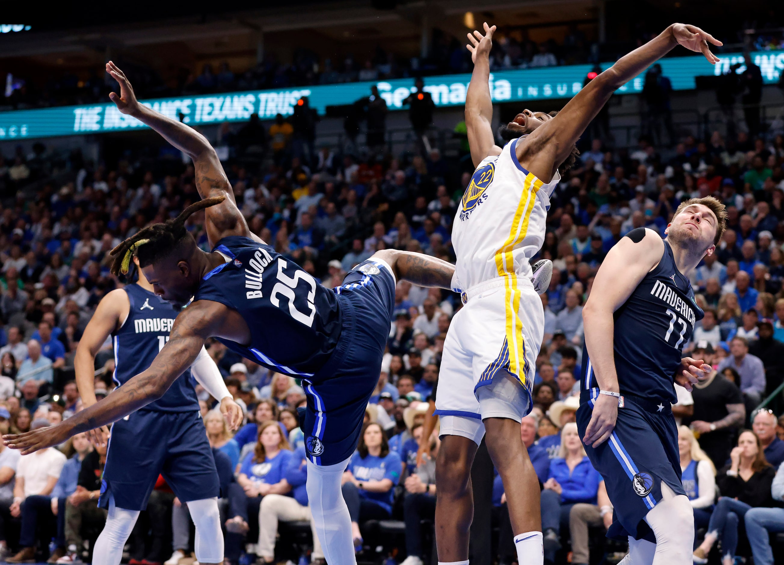 Dallas Mavericks forward Reggie Bullock (25) fouls Golden State Warriors forward Andrew...