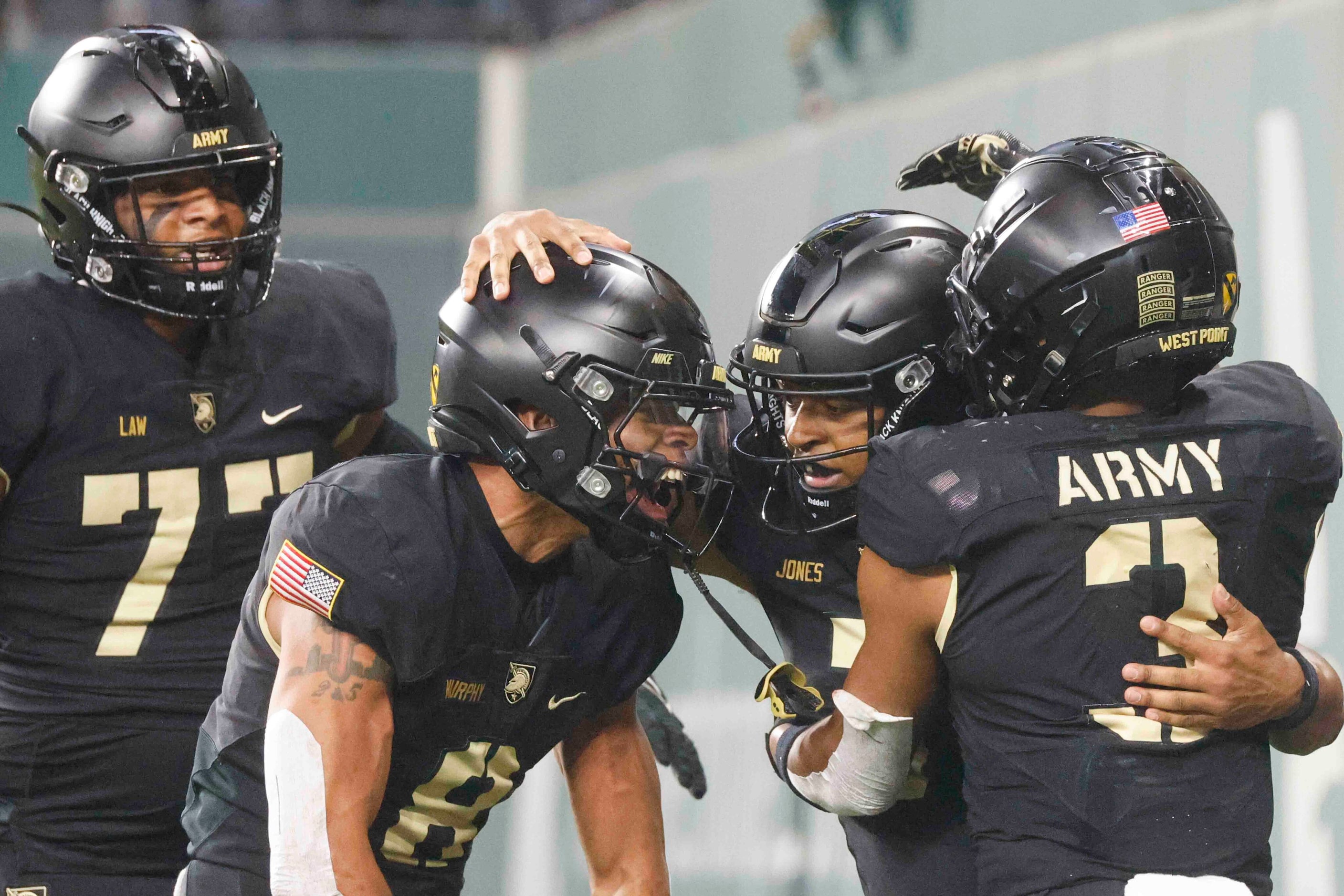 Army players including quarterback Jemel Jones, center, Braheam Murphy (8) and Ay'Jaun...