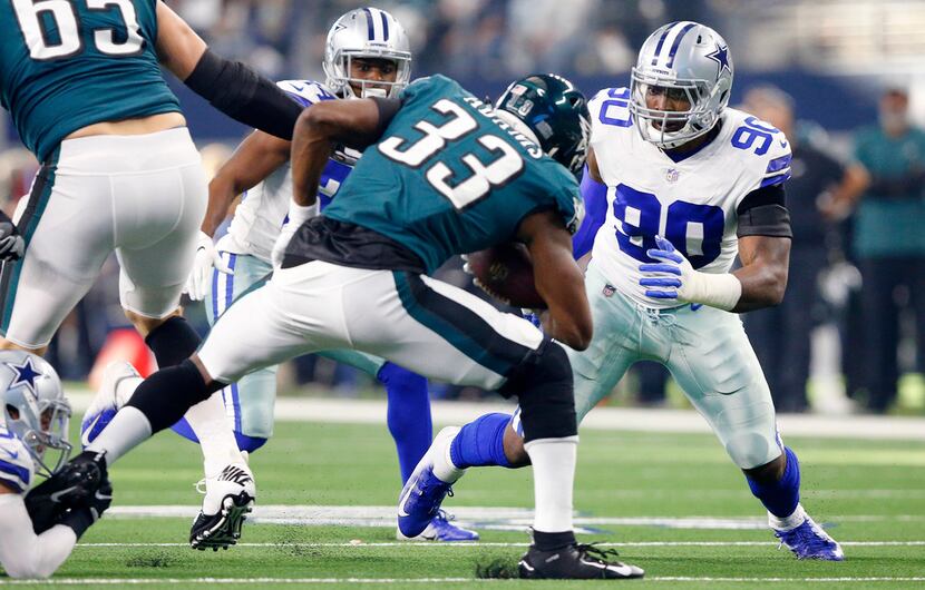 FILE - Cowboys defensive end DeMarcus Lawrence (90) assists on a tackle of Philadelphia...
