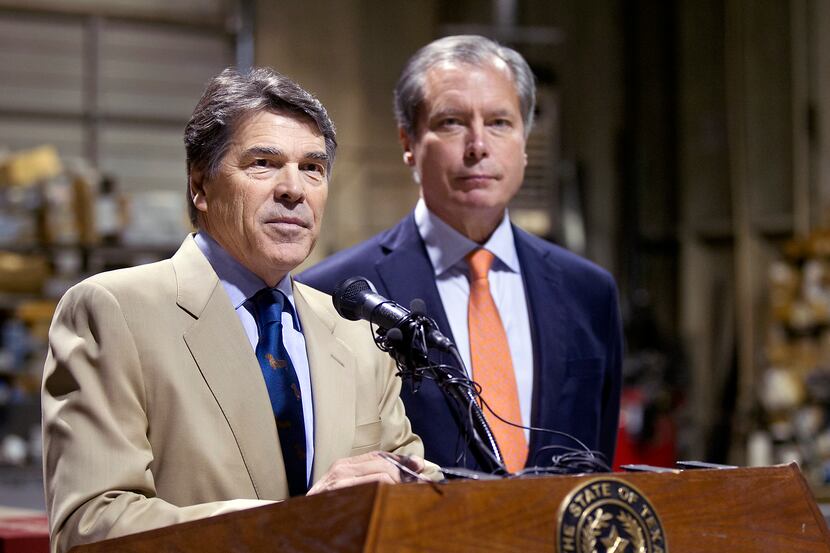 Gov. Rick Perry and Lt. Gov. David Dewhurst visit an East Austin glass company on Tuesday,...