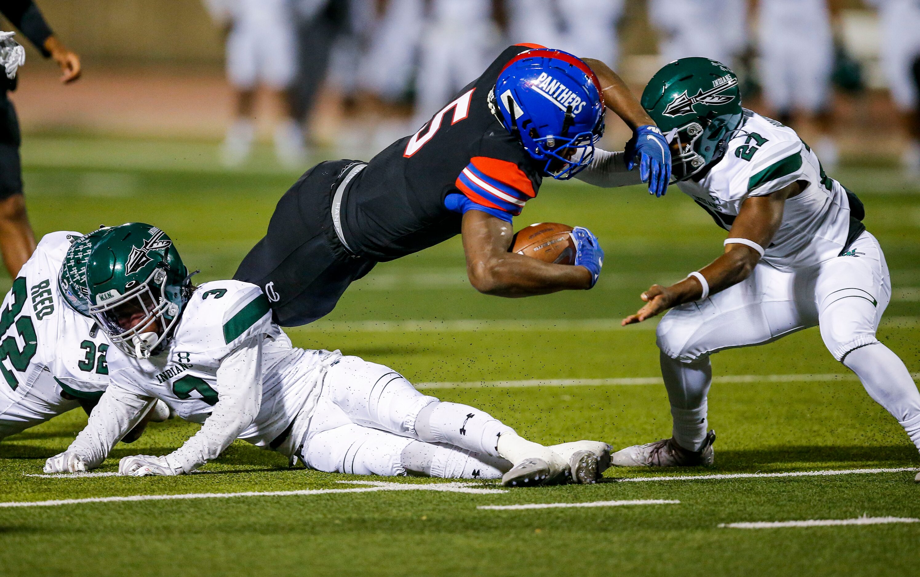 Duncanville senior running back Malachi Medlock (5) is tackled by junior linebacker Robert...