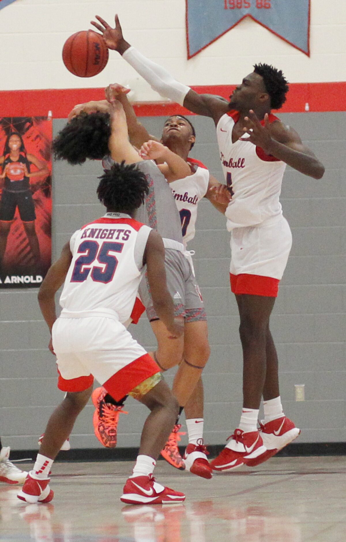 Dallas Kimball forward Kyron Henderson (4), right, leaps to block a shot by Woodrow Wilson's...