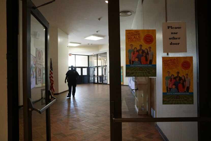 A security guard walks the halls at Manns Education Center in Dallas on June 21, 2017. The...