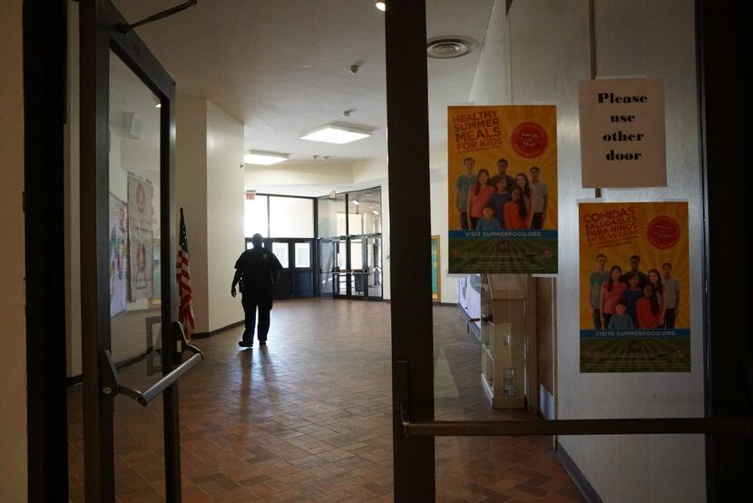 A security guard walks the halls at Manns Education Center in Dallas on June 21, 2017. The...