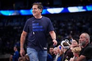 Dallas Mavericks alternate governor Mark Cuban heads for his seat during the first half of...