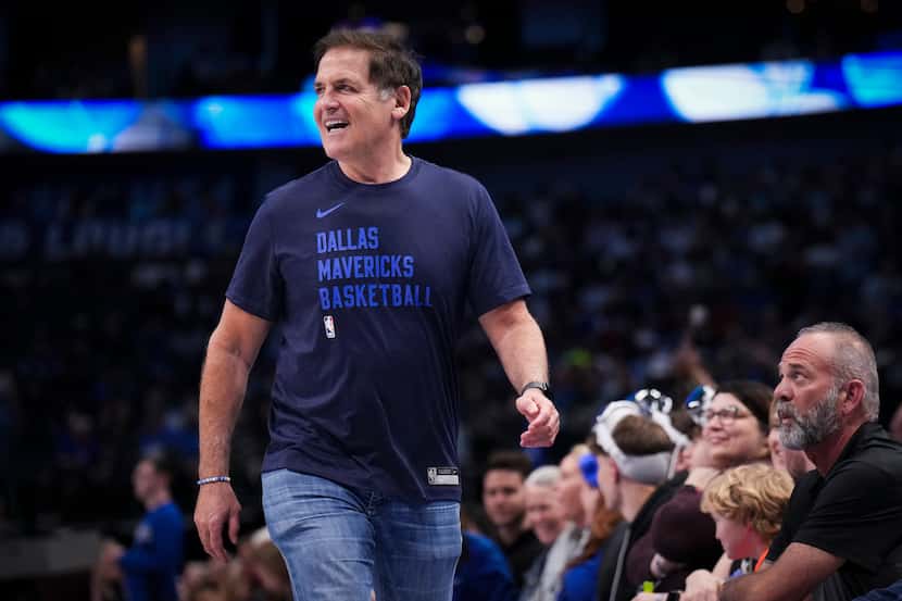 Dallas Mavericks alternate governor Mark Cuban heads for his seat during the first half of...