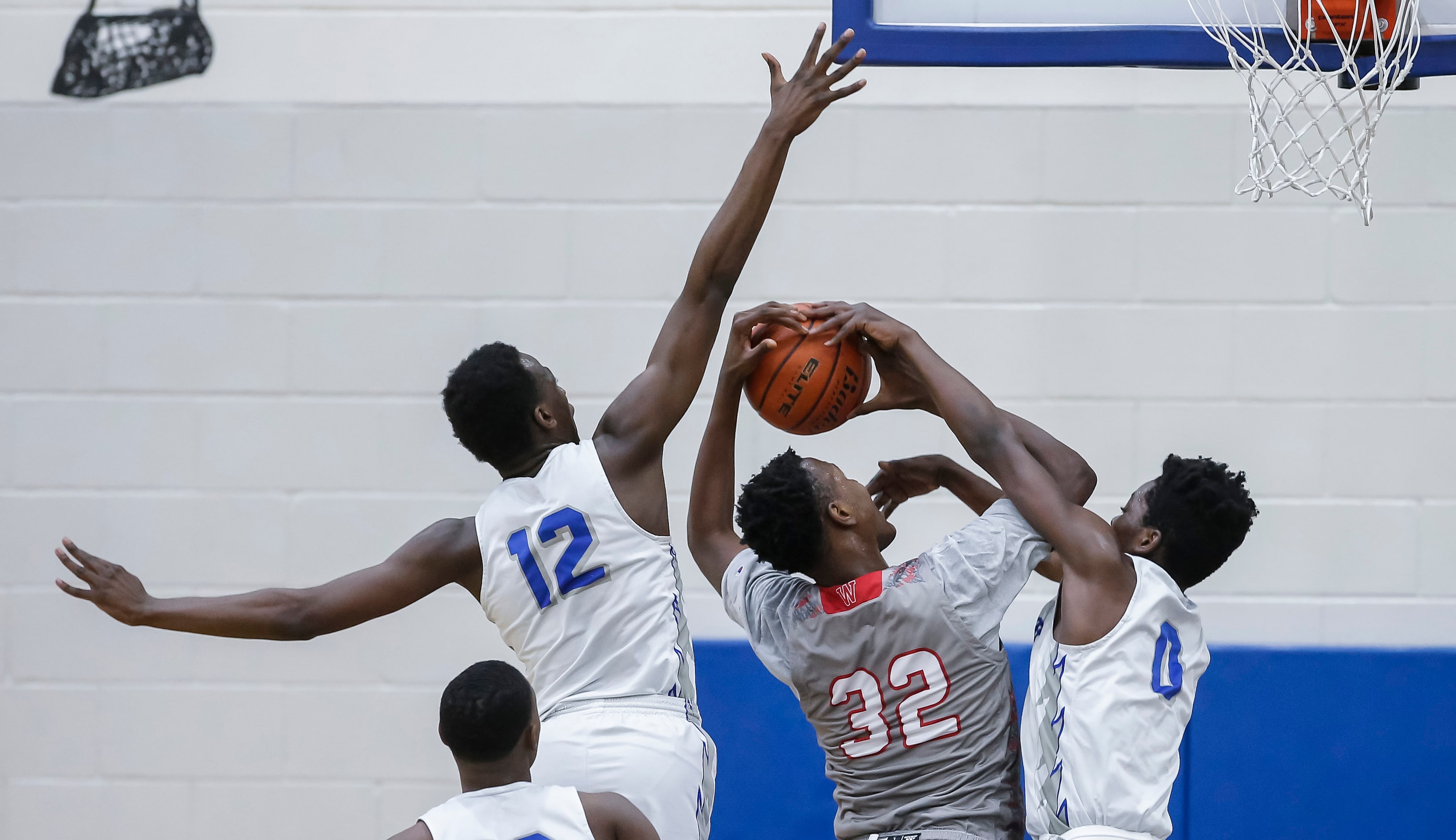 Woodrow Wilson junior forward Deshawn Jagwan (32) attempts a shot as Conrad senior forwards...