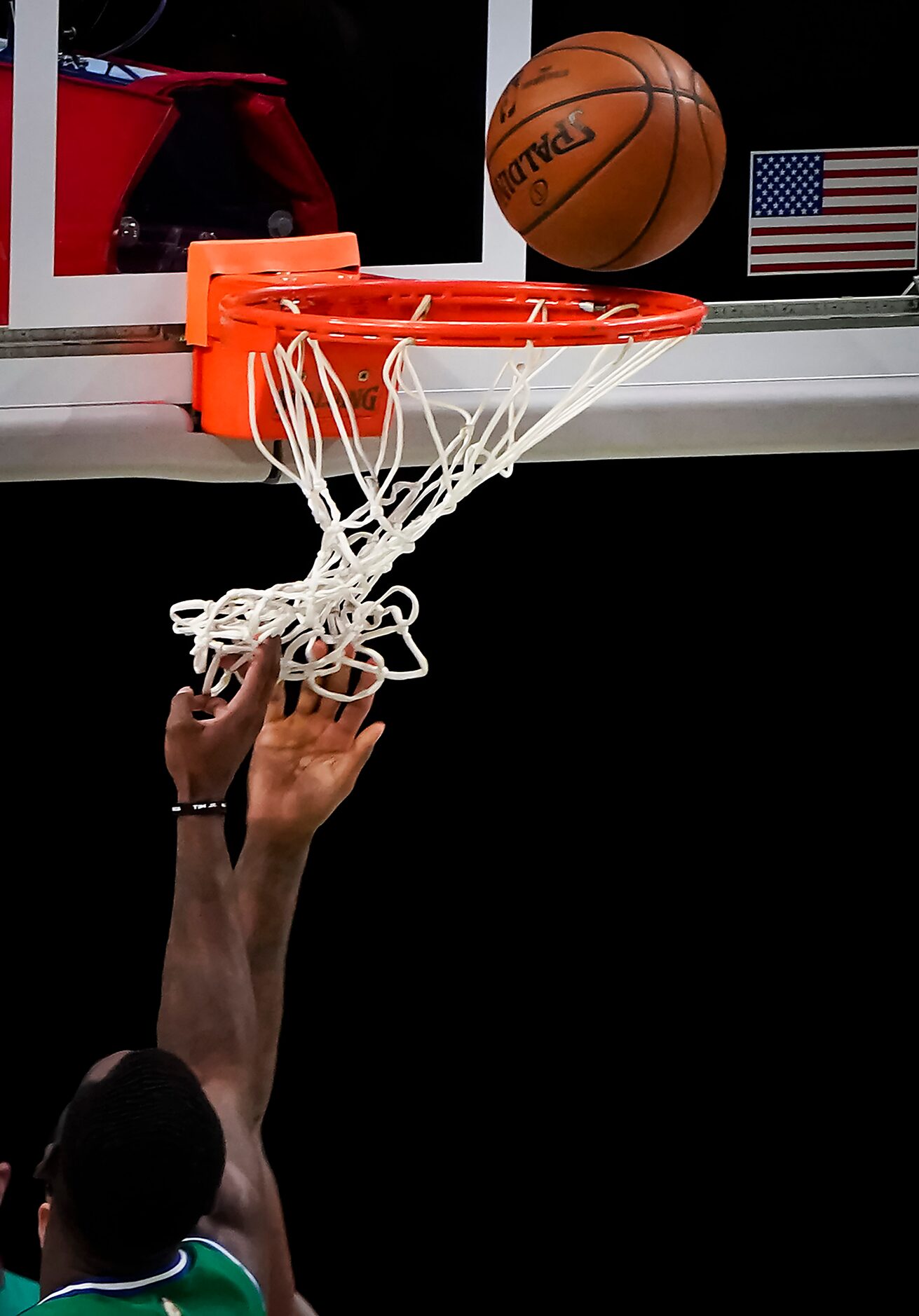 Dallas Mavericks forward Tim Hardaway Jr. gets tangled in the net defending against LA...