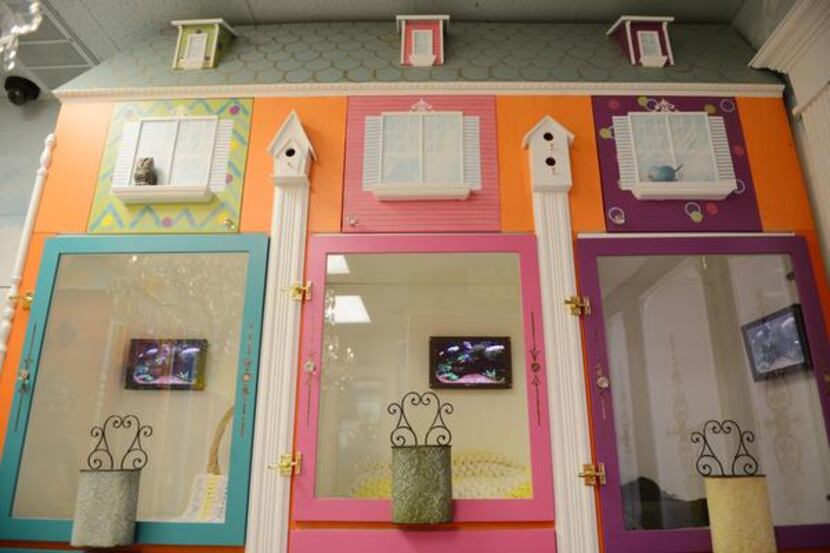 
The condos for cats have a doll house look, with miniature furniture and brightly colored...