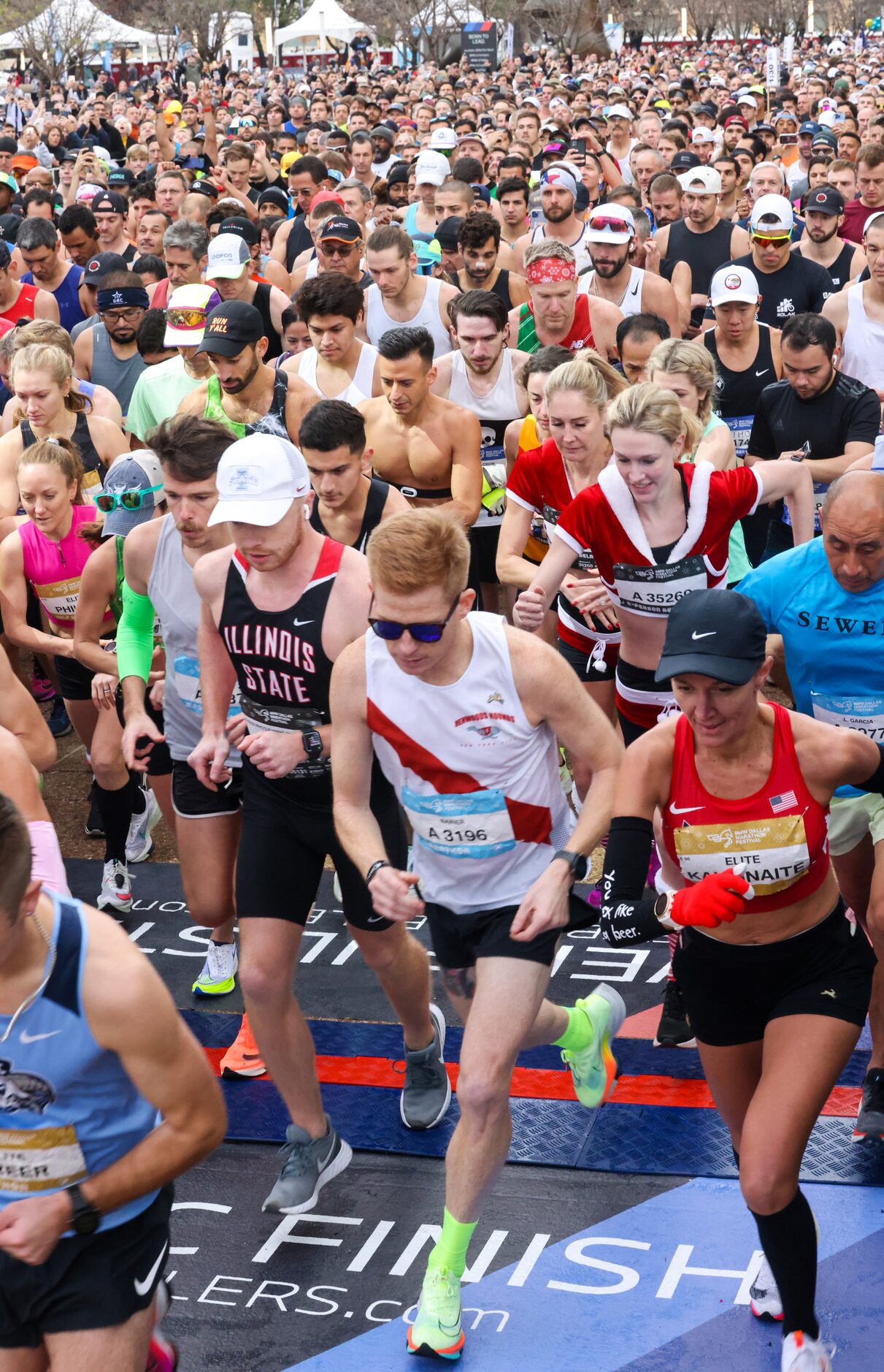 BMW Dallas Marathon runners cross the start line in front of Dallas City Hall on Sunday,...