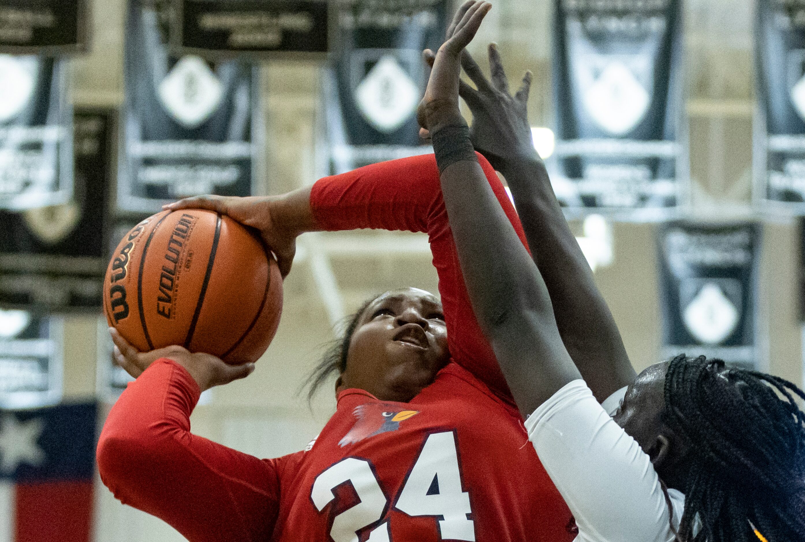 John Paul II High School Taylor Haggan (24) jumps toward the basket as Bishop Lynch High...