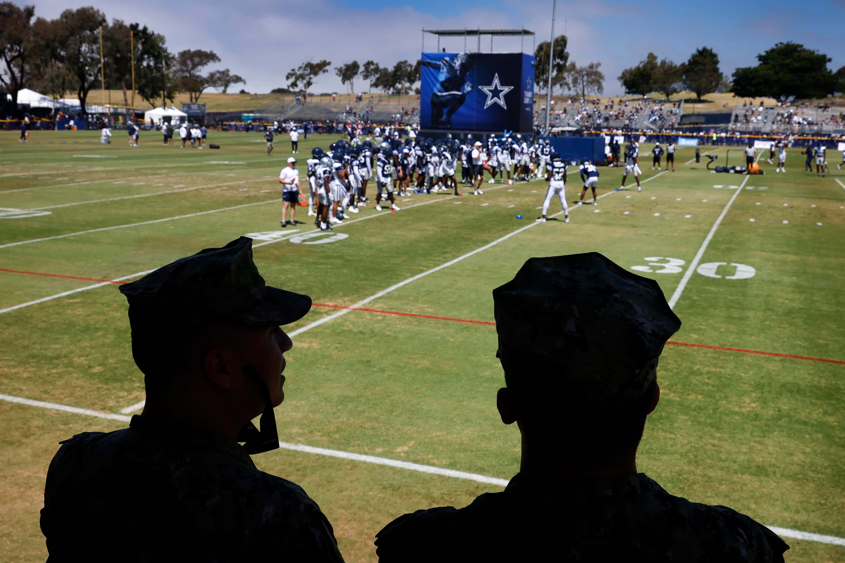 Naval Builder Third Classmen Caleb Alba (left) and Logan Bullock watch the Dallas Cowboys...