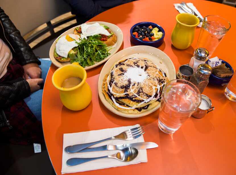 Snooze's BRAVOcado Toast, on the left, is almost upstaged by that giant plate of pancakes....