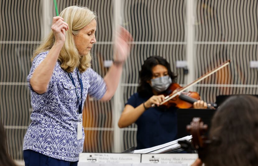 Juli Powers, orchestra director at the Eduardo Mata Montessori School, conducts eight...