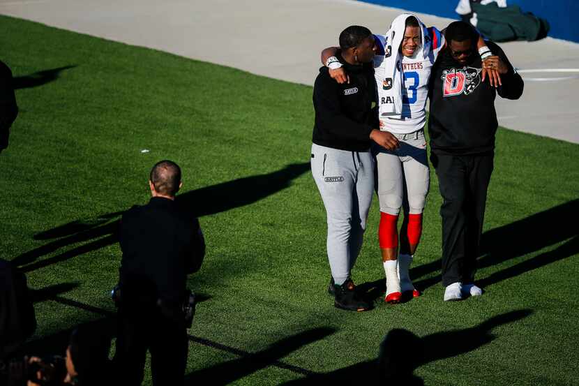 Duncanville quarterback Ja'Quinden Jackson (3) is helped off the field after being injured...