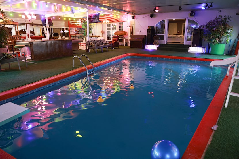 The indoor heated pool inside Jimmy Bradley’s house has a slide and diving board.