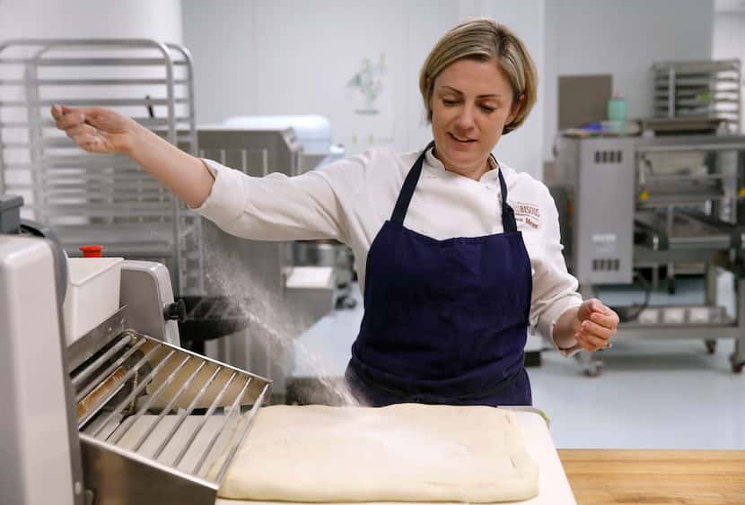 Andrea Meyer, executive pastry chef and owner of Bisous Bisous Patisserie dusts the dough...