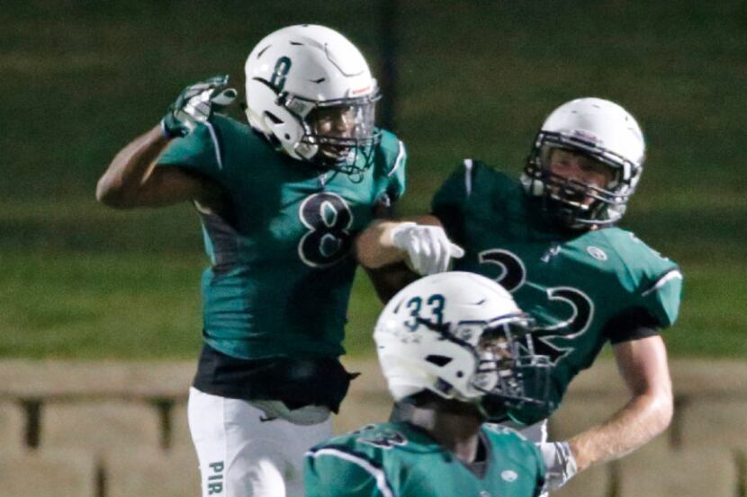 Poteet defender Josh Johnson (8)  and Trevor Keils (22) celebrate a defensive stop in the...