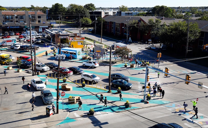 Kids from Sam Tasby Middle School walk across the new plaza with improvements at the Five...