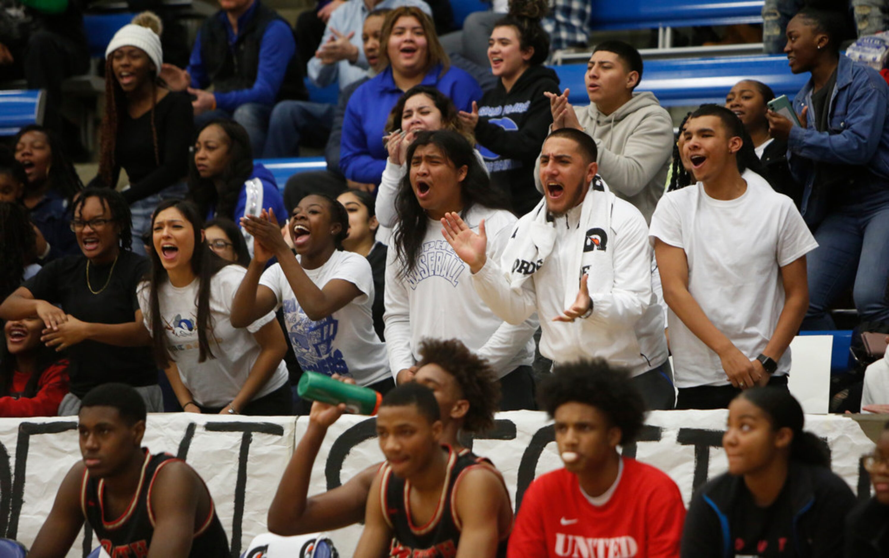 Grand Prairie Gopher fans voice their approval after scoring on a fast break during first...