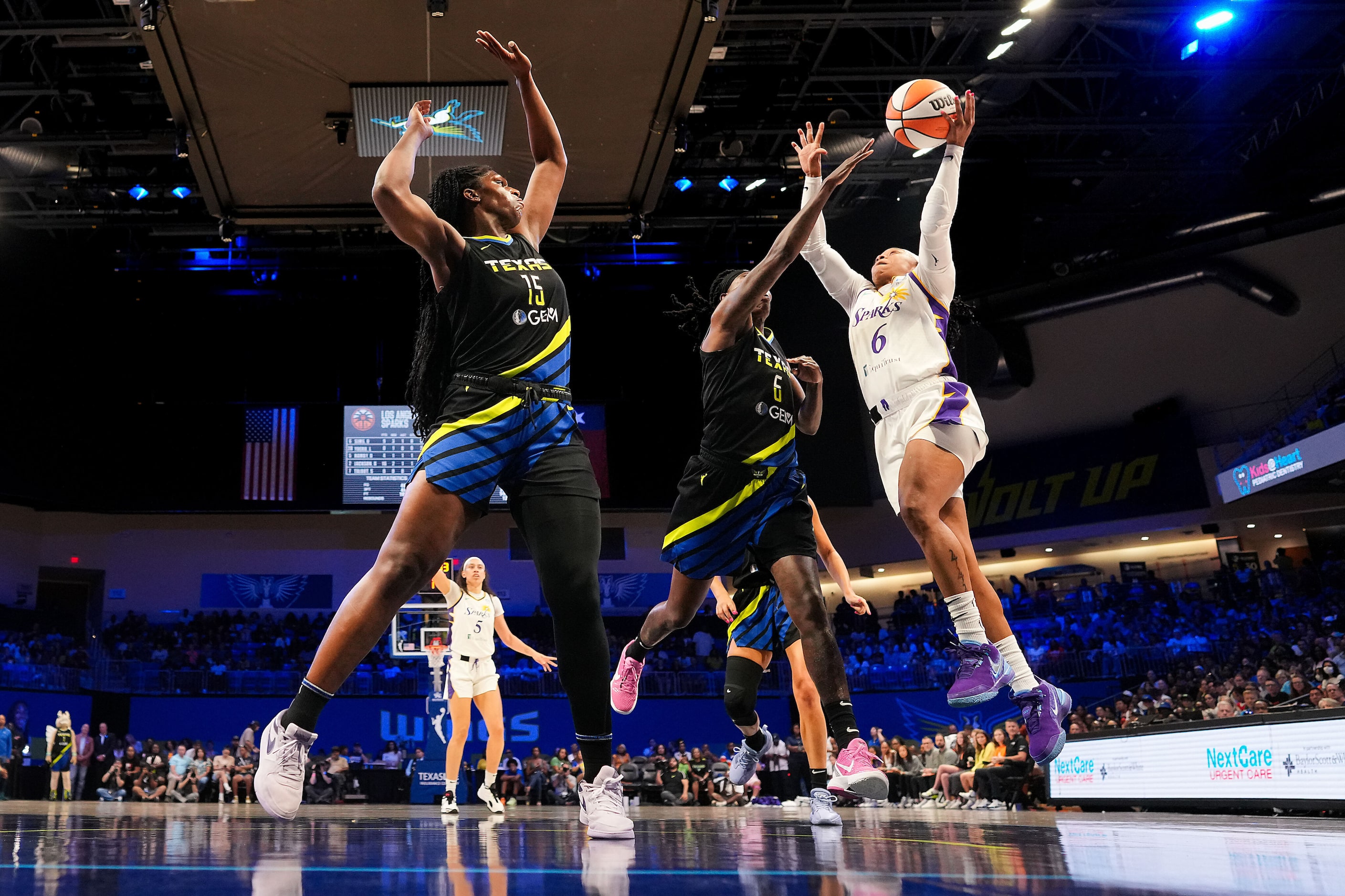 Los Angeles Sparks guard Odyssey Sims (right) drives to the basket against Dallas Wings...