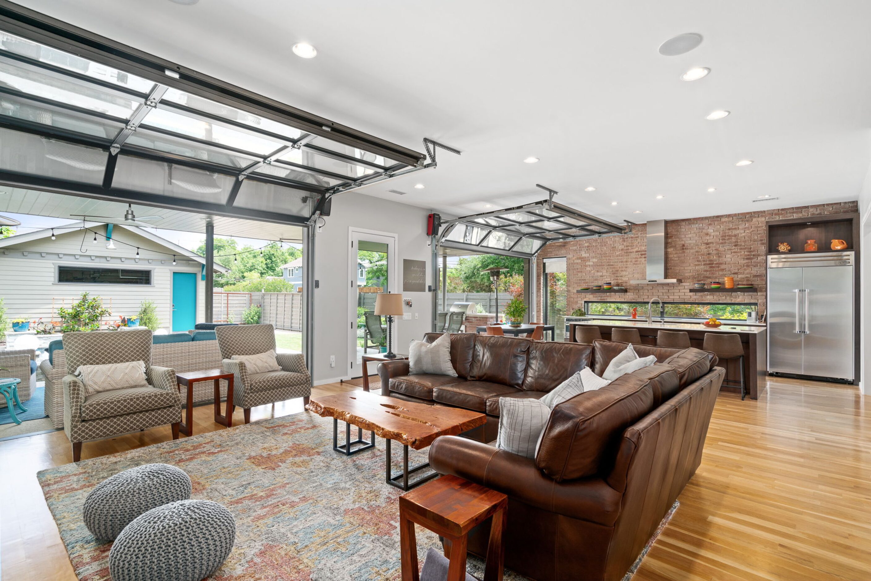 Living and kitchen space with open glass doors